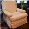 F57. Cream colored club chair. 